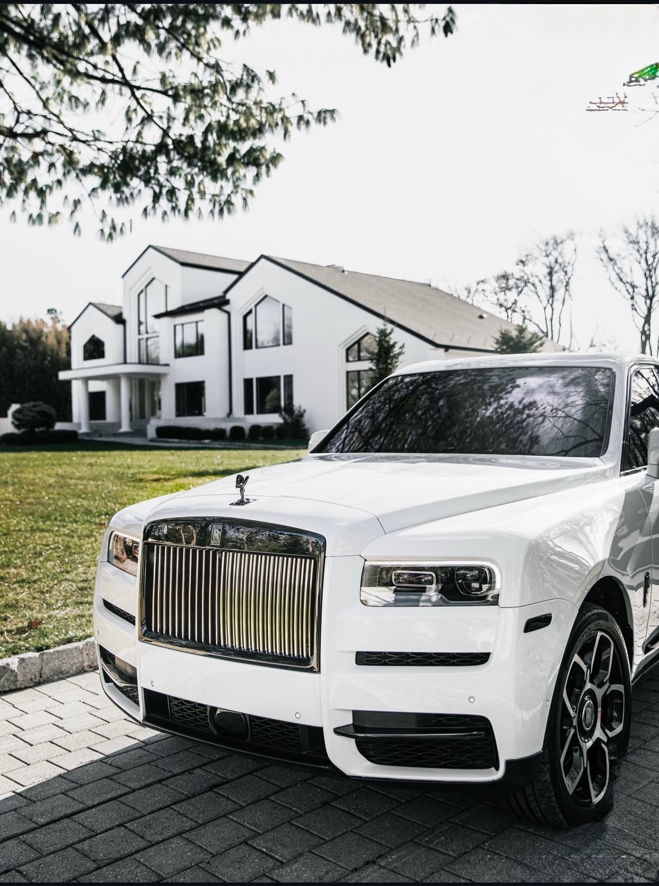 White on white Rolls-Royce Cullinan chauffeur vehicle
